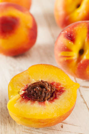 Organic Ripe Orange Peaches on a Backgroundの写真素材