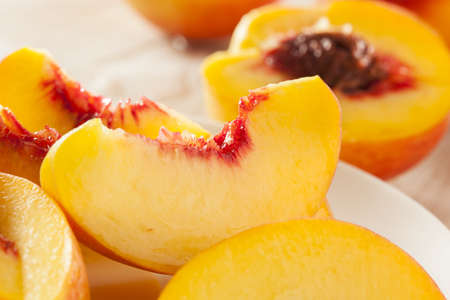 Organic Ripe Orange Peaches on a Background