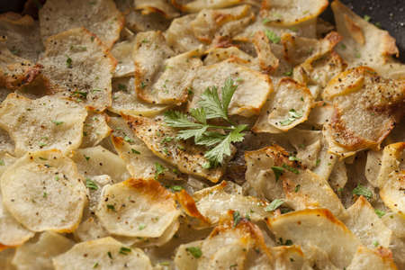 Fresh Homemade Potatoes Anna with Green Parsleyの写真素材