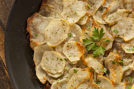 Fresh Homemade Potatoes Anna with Green Parsleyの写真素材