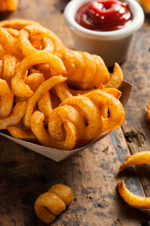 Spicy Seasoned Curly Fries Ready to Eatの写真素材