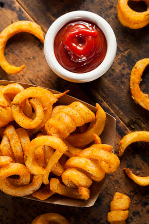 Spicy Seasoned Curly Fries Ready to Eatの写真素材