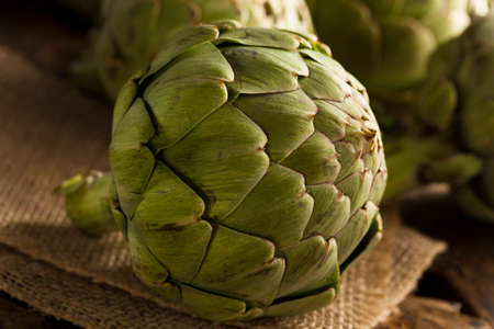 Raw Organic Green Artichokes on a Backgroundの写真素材