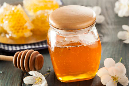 Organic Raw Golden Honey Comb on a Backgroundの写真素材