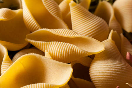 Assorted Homemade Dry Italian Pasta on a Backgroundの写真素材