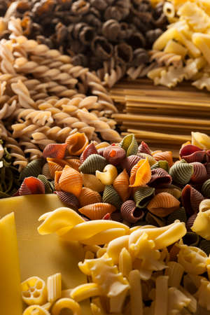 Assorted Homemade Dry Italian Pasta on a Backgroundの写真素材