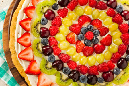 Homemade Natural Fruit Pizza with Frosting and Berriesの写真素材