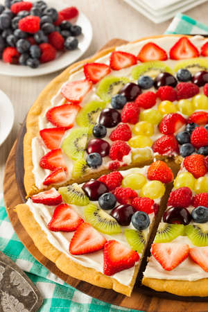 Homemade Natural Fruit Pizza with Frosting and Berriesの写真素材