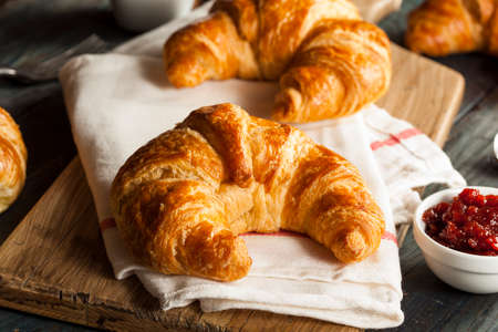 Homemade Flakey French Croissants on a Backgroundの写真素材