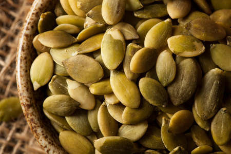 Raw Organic Pumpkin Pepita Seeds in a Bowlの写真素材
