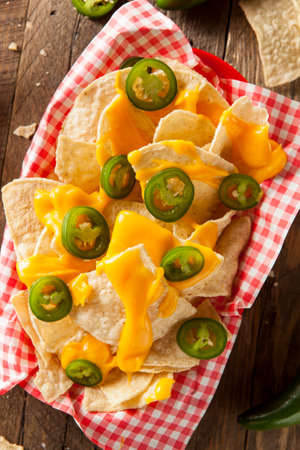 Homemade Nachos with Cheddar Cheese and Jalapenosの写真素材