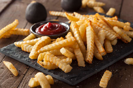 Unhealthy Baked Crinkle French Fries with Ketchup