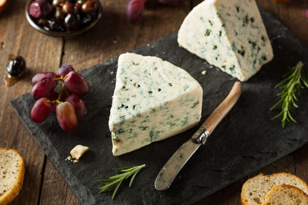 Organic Blue Cheese Wedge with Olives and Grapesの写真素材