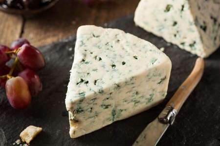 Organic Blue Cheese Wedge with Olives and Grapesの写真素材