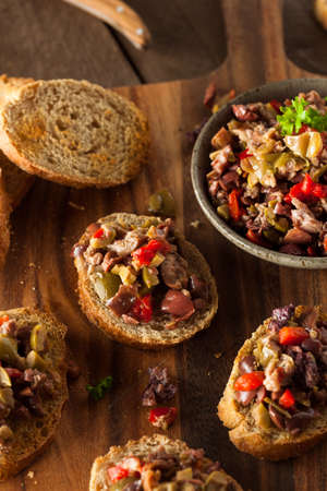 Homemade Mixed Olive Tapenade on Whole Wheat Crostiniの写真素材