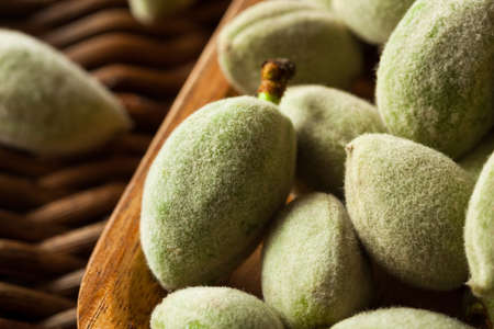 Organic Fresh Green Almonds in a Bowlの写真素材
