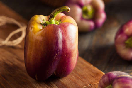Organic Purple Bell Peppers on a Backgroundの写真素材