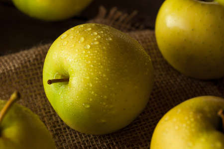 Raw Organic Golden Delicious Apples Ready to Eatの写真素材
