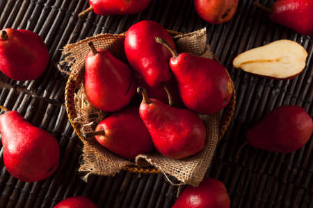 Raw Organic Red Pears in a Basketの写真素材