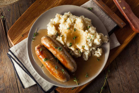 Homemade Bangers and Mash with Herbs and Gravyの写真素材