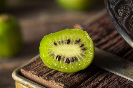 Green Organic Kiwi Berries in a Bowlの写真素材