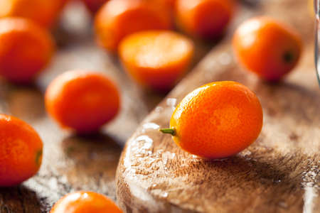 Raw Organic Orange Kumquats in a Bowlの写真素材