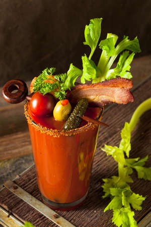 Homemade Bacon Spicy Vodka Bloody Mary with Tomatos, Olive and Celeryの写真素材