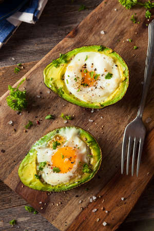 Homemade Organic Egg Baked in Avocado with Salt and Pepperの写真素材