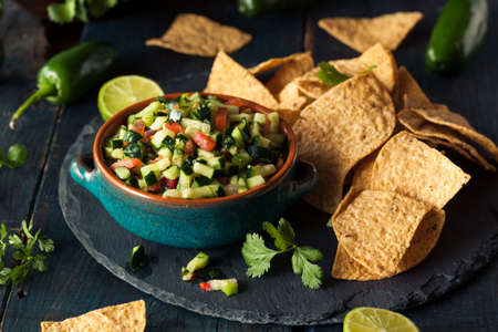 Raw Homemade Cucumber Pico De Gallo Salsa with Chipsの写真素材