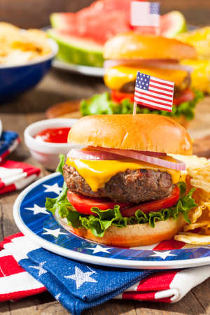 Homemade Memorial Day Hamburger Picnic with Chips and Fruitの写真素材