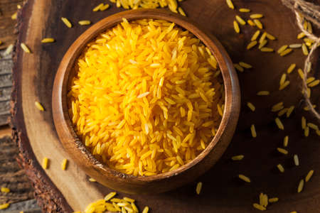 Raw Organic Yellow Saffron Rice in a Bowlの写真素材