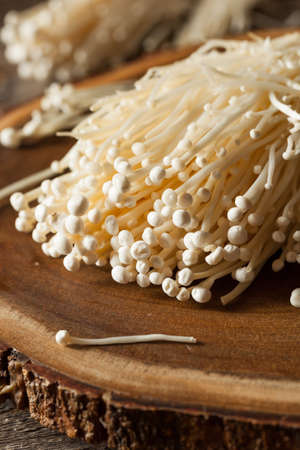 Raw Organic Enoki Mushrooms in a Bunchingの写真素材