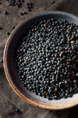 Raw Organic Black Lentils in a Bowlの写真素材