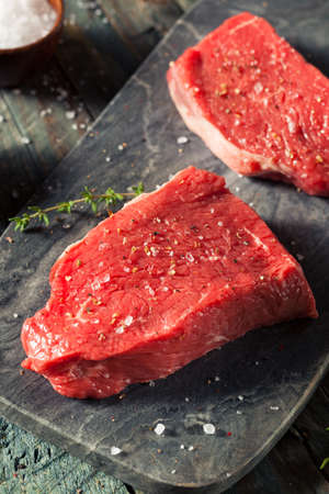 Raw Organic Grass Fed Sirloin Steak with Salt and Pepperの写真素材