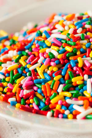 Bright Colored Rainbow Sprinkles in a Bowlの写真素材