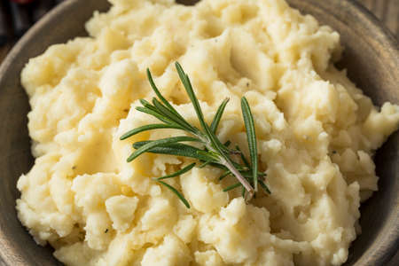 Homemade Thanksgiving Mashed Potatoes with butter and Rosemaryの写真素材