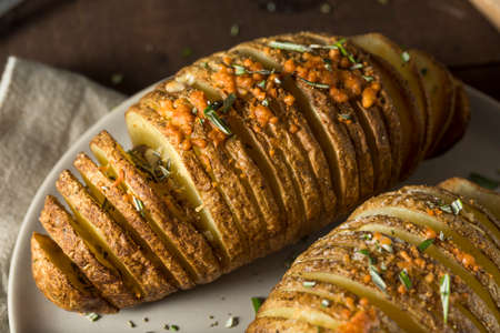 Homemade Cheesy Hasselback Potato with Fresh Herbsの写真素材