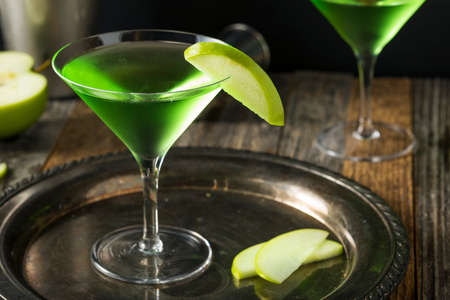 Homemade Green Alcoholic Appletini Cocktail with Apple Garnishの写真素材