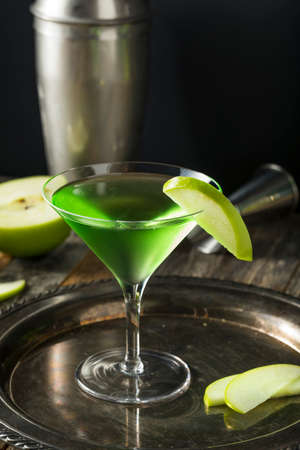 Homemade Green Alcoholic Appletini Cocktail with Apple Garnishの写真素材