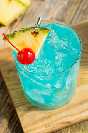Refreshing Blue Hawaii Cocktail Punch with Pineapple and Cherryの写真素材