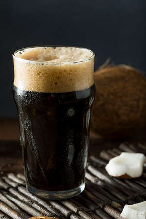Refreshing Cold Dark Coconut Beer in a Pint Glass