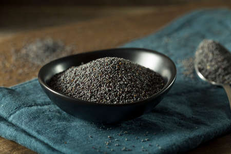 Raw Organic Black Poppy Seeds in a Bowlの写真素材