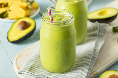 Healthy Homemade Avocado Smoothie with Spinach Pineapple and Yogurtの写真素材