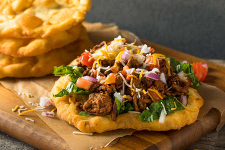 Homemade Indian Fry Bread Tacos with Ground Beef Lettuce and Tomato