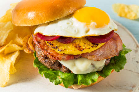 Homemade Aussie Pineapple and Beet Cheeseburger with Egg and Baconの写真素材