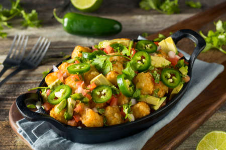 Homemade Mexican Tater Tot Nachos Tachos with Cheese Cilantro and Jalapenoの写真素材