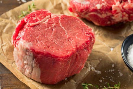 Raw Organic Grass Fed Filet Mignon Steak with Salt and Herbsの写真素材