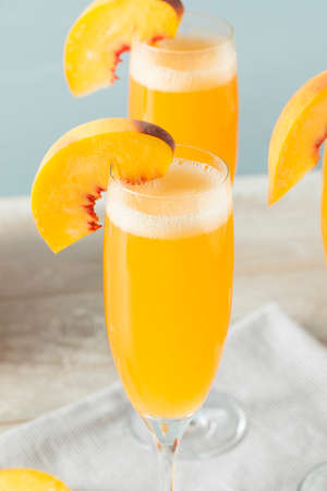 Sweet Bubbly Peach Bellini Mimosa with Champagneの写真素材