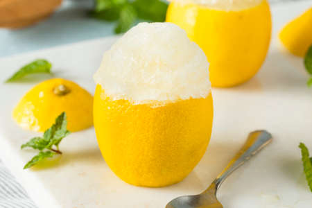 Homemade Yellow Lemon Italian Ice in a Lemonsの写真素材