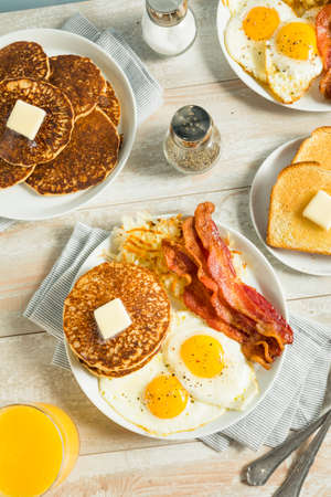 Healthy Full American Breakfast with Eggs Bacon and Pancakesの写真素材